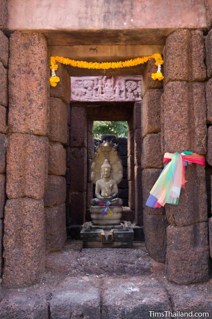 Buddha and replica lintel in Ku Ban Daeng Khmer ruin central tower