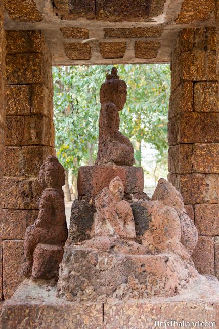 laterite carving, perhaps of Phra Malai, in shrine of Ku Mithila Khmer ruin