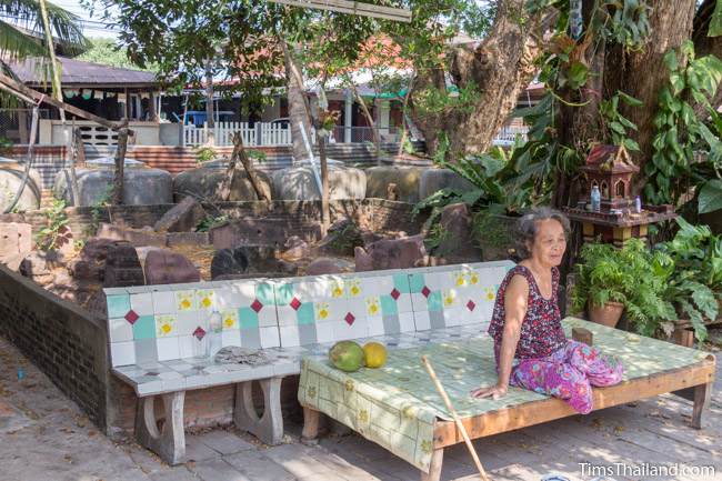 woman sitting in front of Ku Ban Hua Sa Khmer ruin