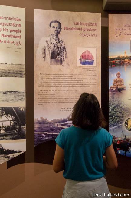 woman looking at historical panel in Narathiwat City Museum