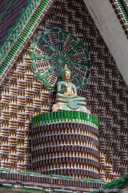 Buddha and dharma wheel at Wat Khuat bottle temple