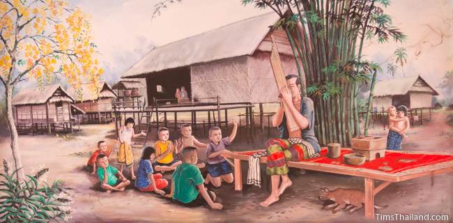 mural of man playing kaen to group of children