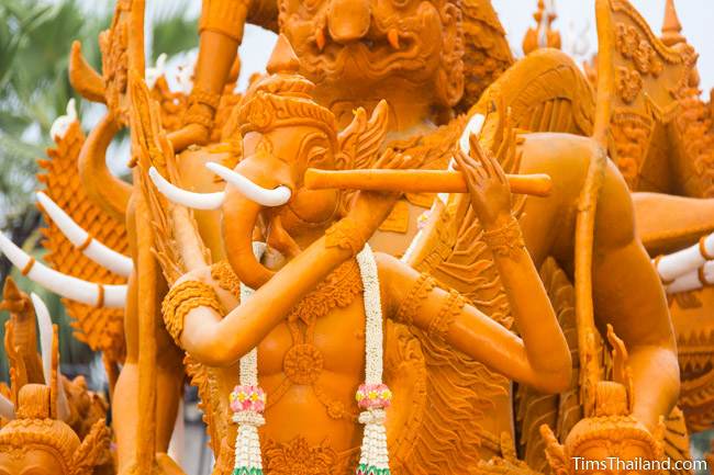 elephant-headed creature playing a flute on a Khao Phansa candle parade float