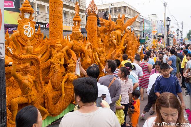 people looking at a Khao Phansa candle parade float