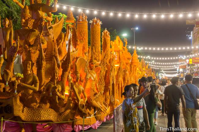 people looking at a Khao Phansa candle parade float