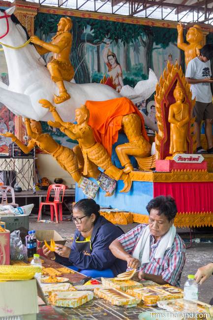 women carving wax pieces for a Khao Phansa candle parade float