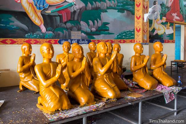 wax disciples for a Khao Phansa candle parade float sitting on a table