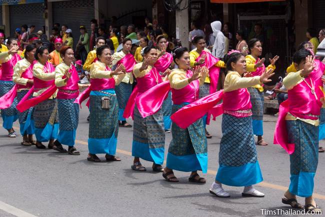 dancers wearing traditional Thai dresses in Khao Phansa candle parade