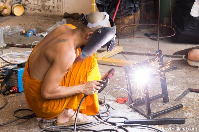 monk welding for making a Khao Phansa candle parade float