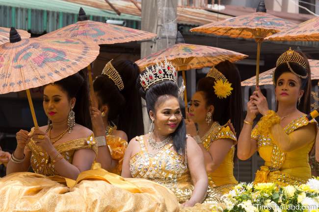 women with umbrellas in a Khao Phansa candle parade