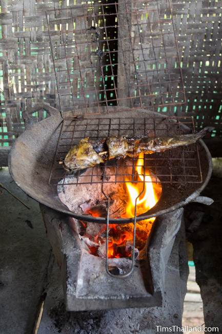 fish cooking on a charcoal grill