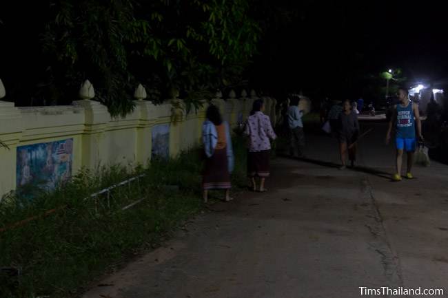 taking food to the temple at night for Boon Khao Pradap Din