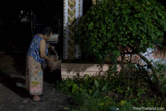 taking food to the temple at night for Boon Khao Pradap Din