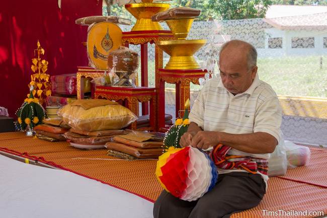 man decorating tent for Kathin celebration