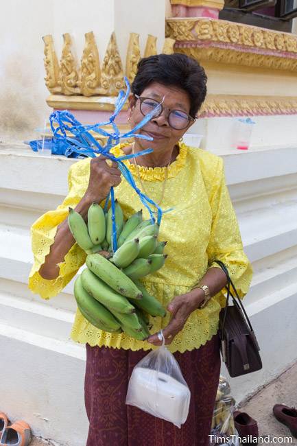 woman holding bananas for Kathin celebration