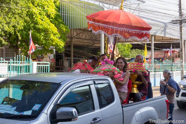 people in back of pickup truck in Kathin celebration parade