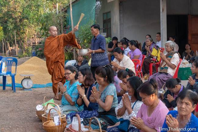 monk blessing people with water at Boon Berk Bahn