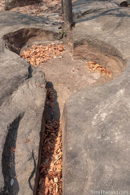 natural split in the sandstone and a pothole