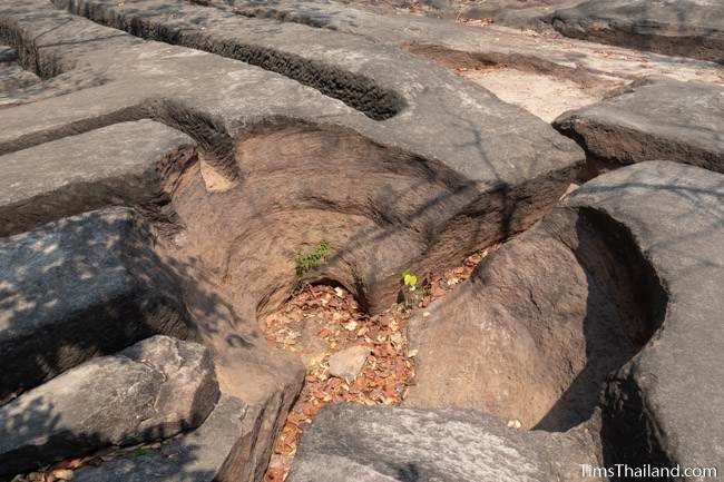 pothole amidst sandstone blocks not yet removed