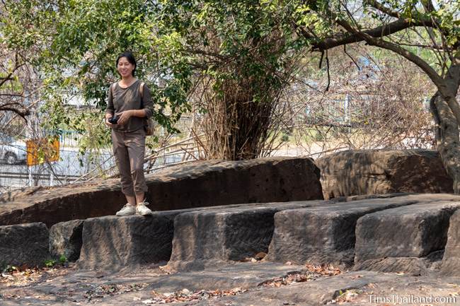 woman standing on sandstone blocks not yet removed