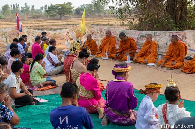 Vessantara, his wife, parents, and kids sitting in front of monks