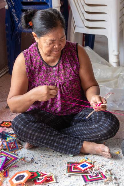 woman making decoration out of yarn