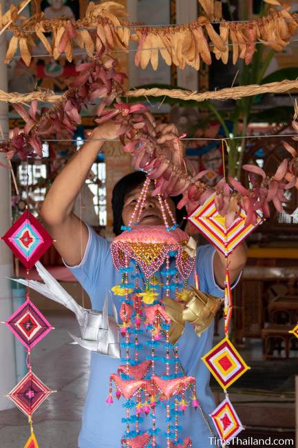 woman hanging decorations