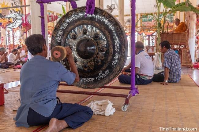 man hitting a gong