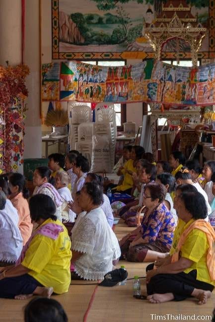 people listening to monks speaking