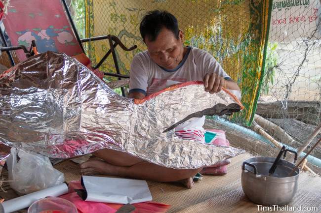 man making fish decoration