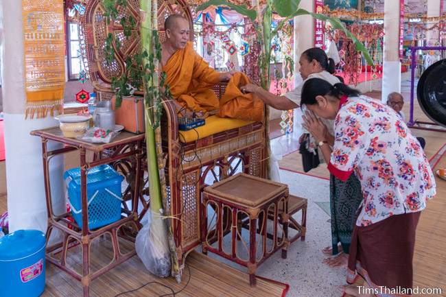 woman giving monk money