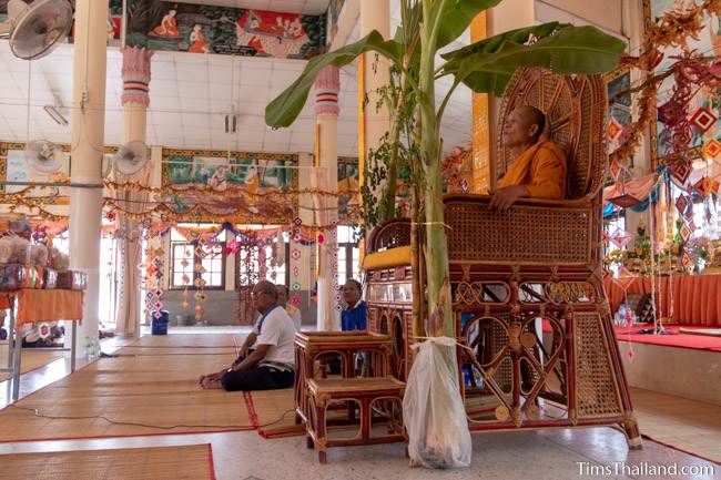 people listening to monks speaking