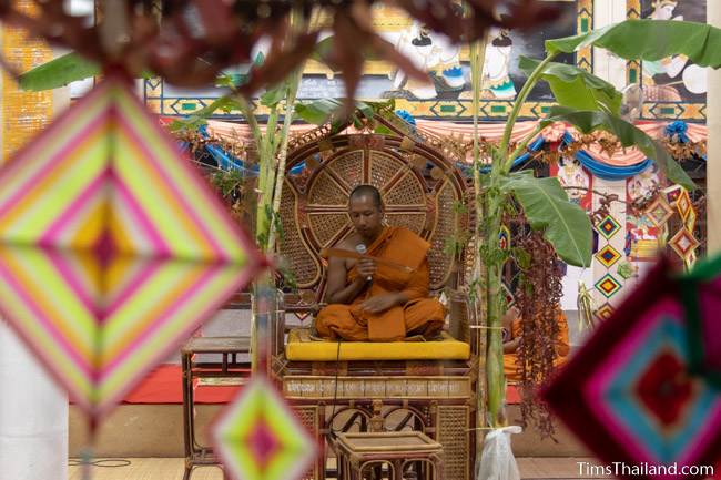 monk reading from palm leaf manuscript