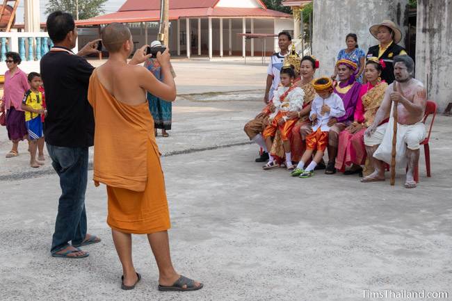 monk taking photo of Vessantara and his family