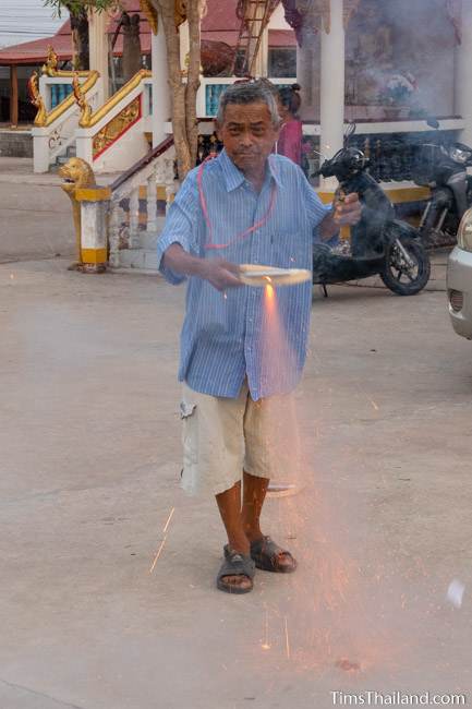 man holding firework in his hand