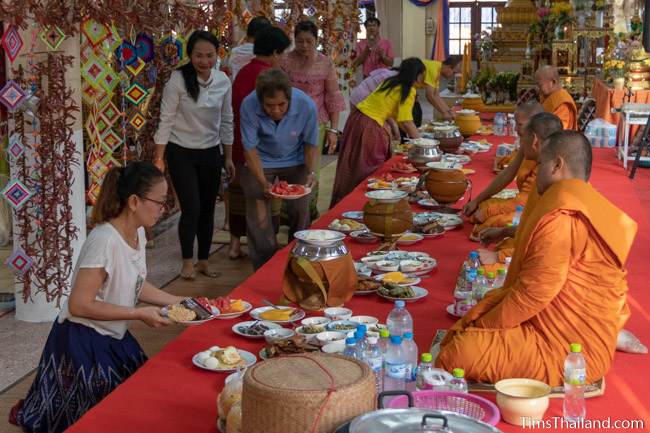 people serving food to monks