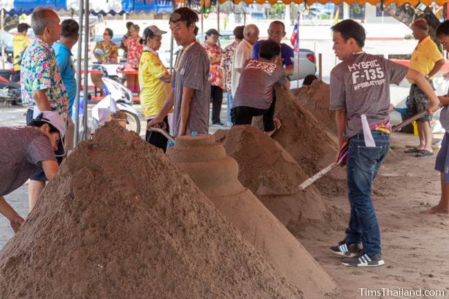 people building sand stupas