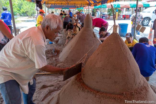 people building sand stupas