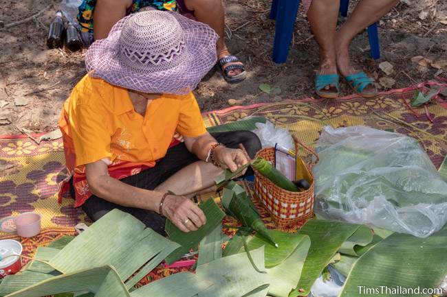 woman cutting banana leaves