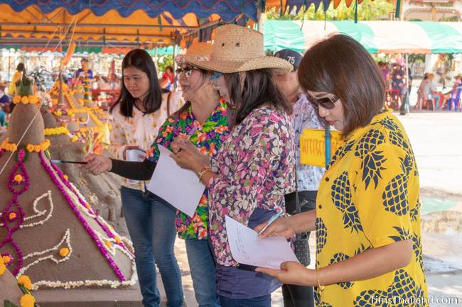 judges looking at a sand stupa