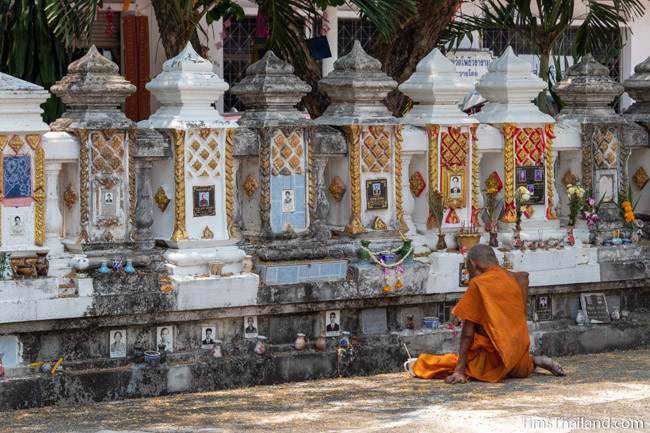 monk with ancestor vault at temple