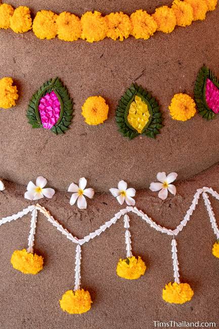 close-up of flowers on a finished sand stupa