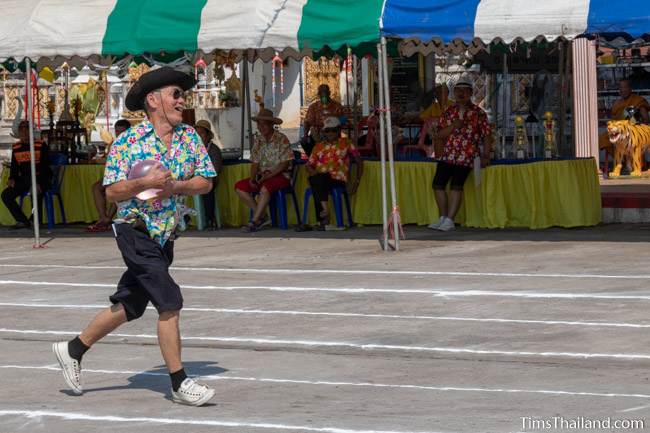 man running with a water balloon