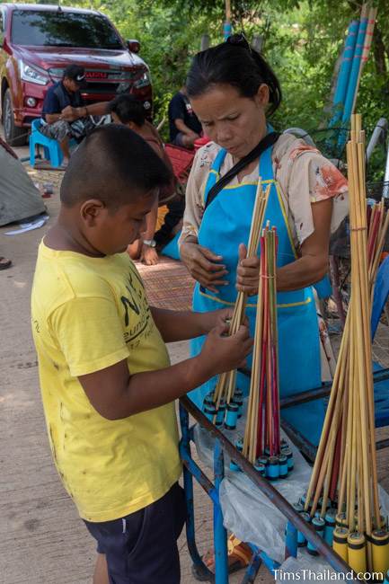 boy buying mini rockets