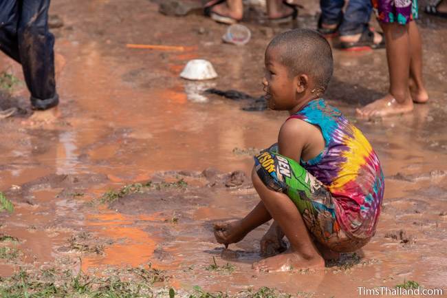 boy playing in mud