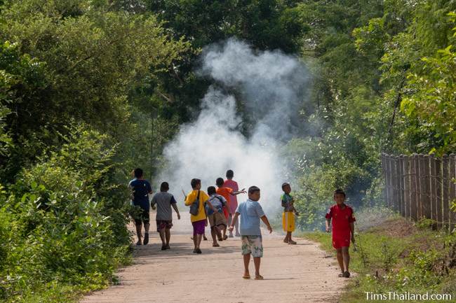 boys standing around smoke from mini rockets