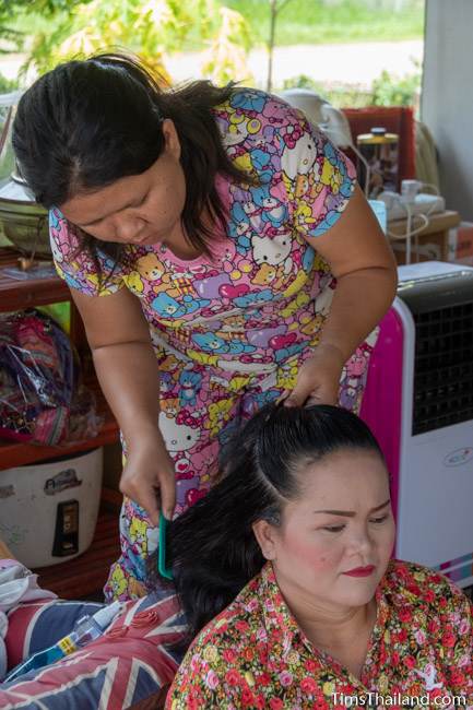 woman doing another woman's hair