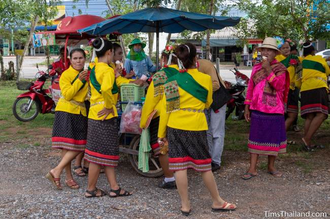 women in Thai traditional clothes eating ice cream