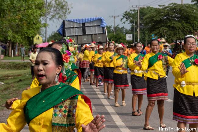 women in Thai traditional clothes dancing in the parade