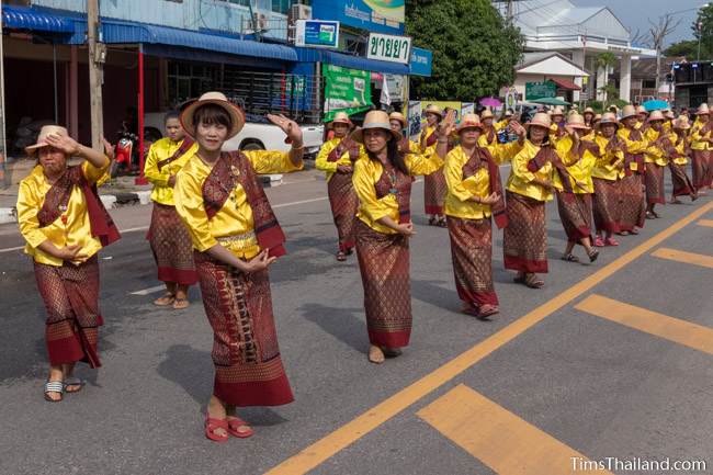 women in Thai traditional clothes dancing in the parade